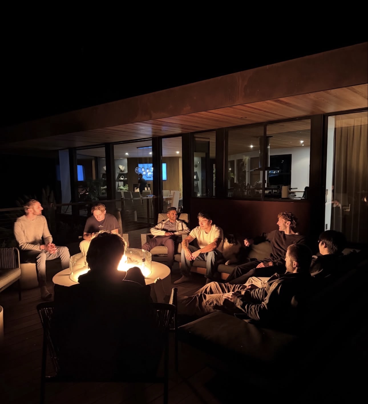 People gathered around a fire pit at night